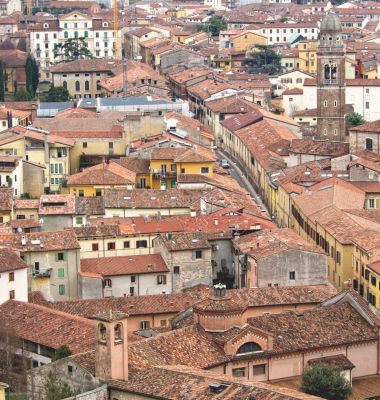 Verona, Italia. Centro città. Tetti rossi. Città storica antica. Coperture in tegole di terracotta. Strade strette. Edifici antichi. Architettura medievale. Tessuto urbano compatto. Centro storico. Muratura tradizionale.